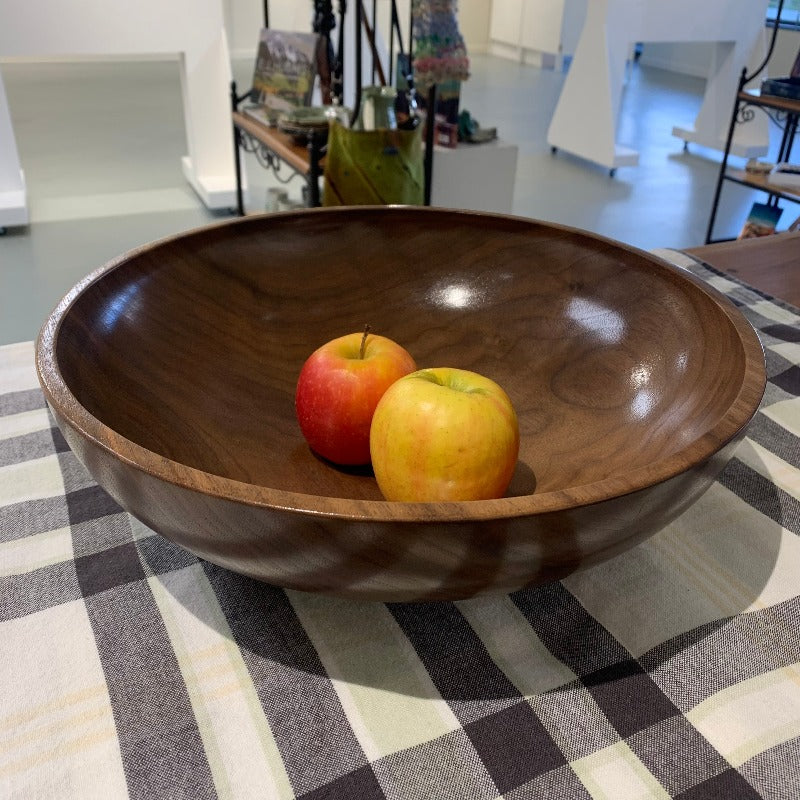 Black walnut bowl with red and yellow apples in it