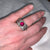 Woman wearing sterling silver ring with pink stone