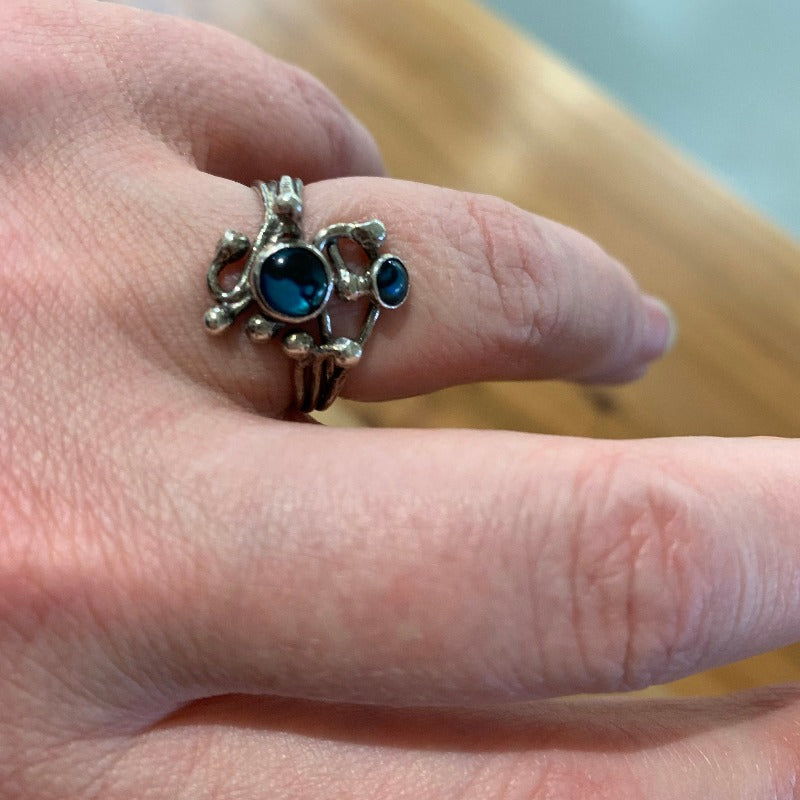 Woman wearing silver ring with blue stones