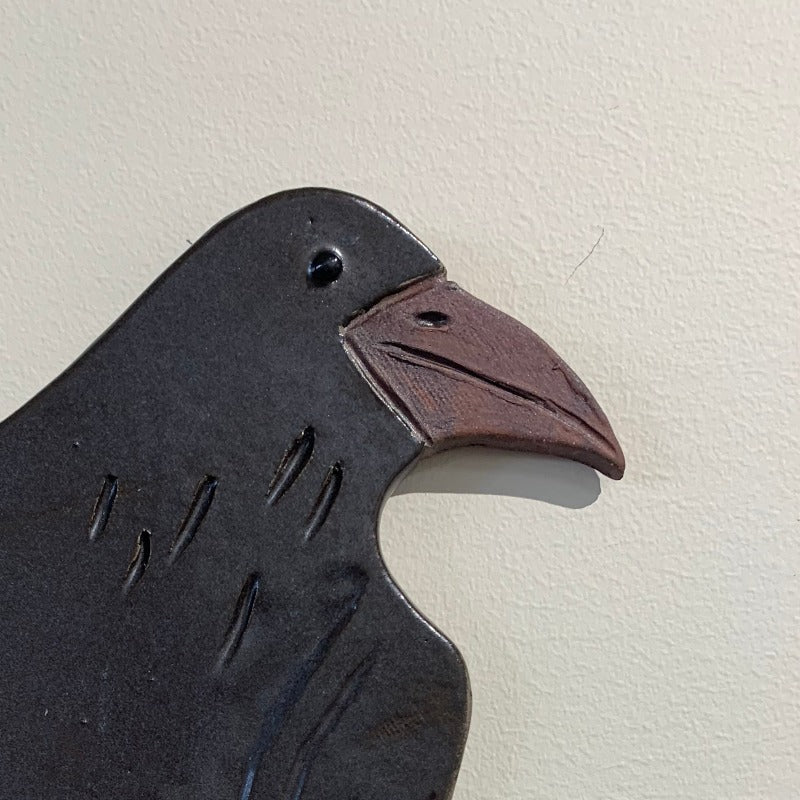 Detail of black crow wall hanging