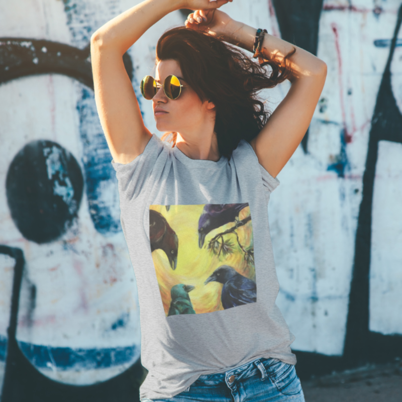 Woman wearing grey tshirt with decal featuring 4 crows