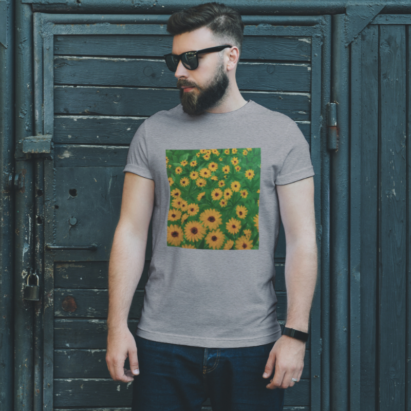 Man wearing grey tshirt with decal of green grass and yellow flowers