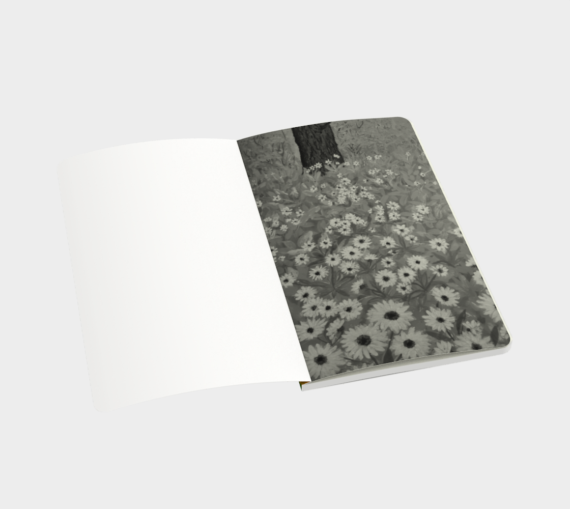Open notebook depicting black and white print of painting of tree trunk surrounded by grass and yellow flowers