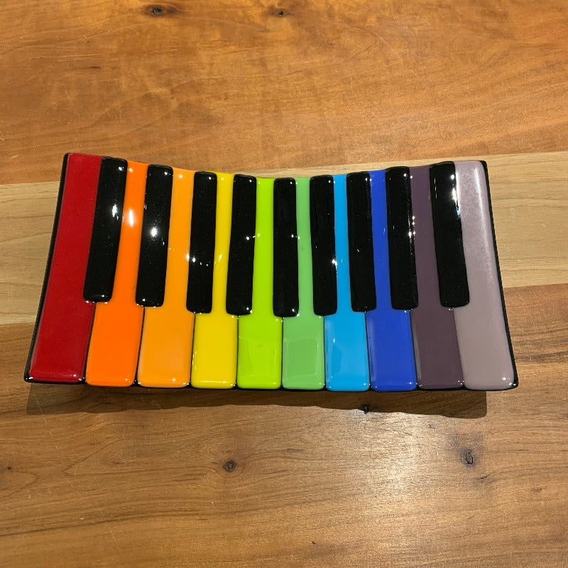 Glass dish shaped like multicoloured piano keys