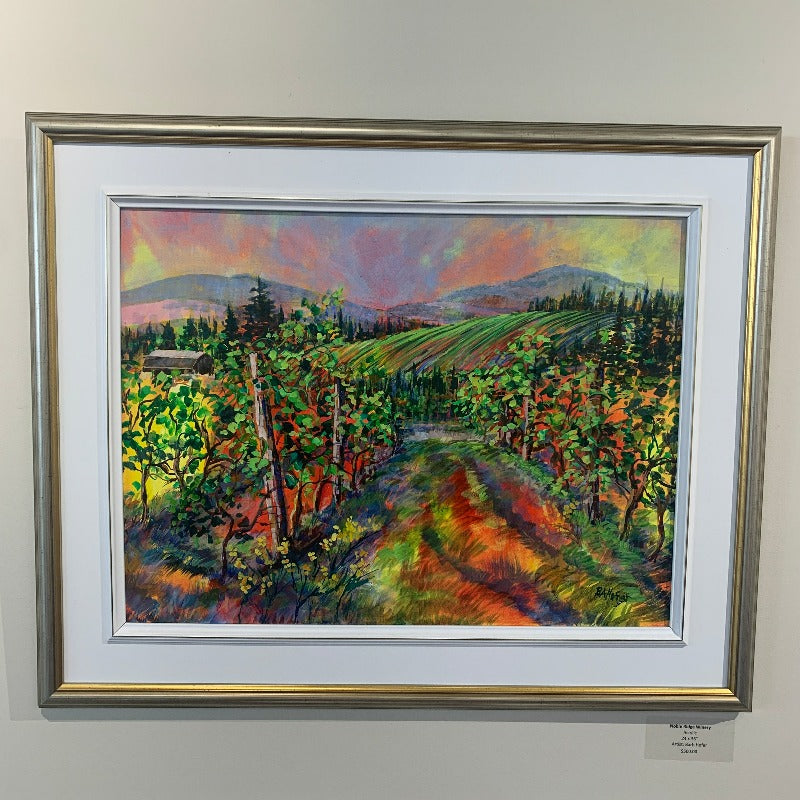Colourful painting of Noble Ridge Winery with dramatic sky, in gold frame.