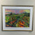Colourful painting of Noble Ridge Winery with dramatic sky, in gold frame.
