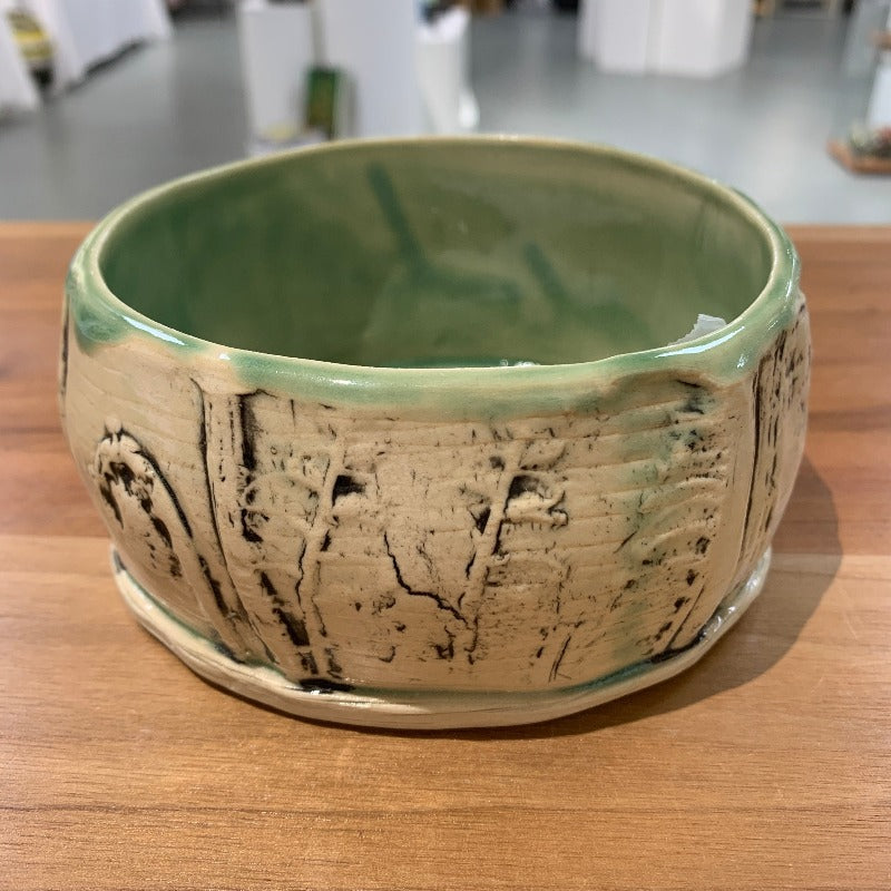Bowl embossed with stylized ferns, cream exterior with black highlights, light green interior
