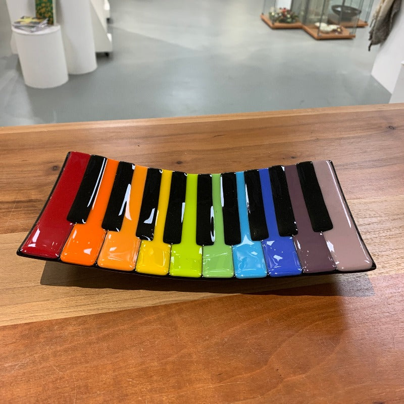 Glass dish shaped like multicoloured piano keys