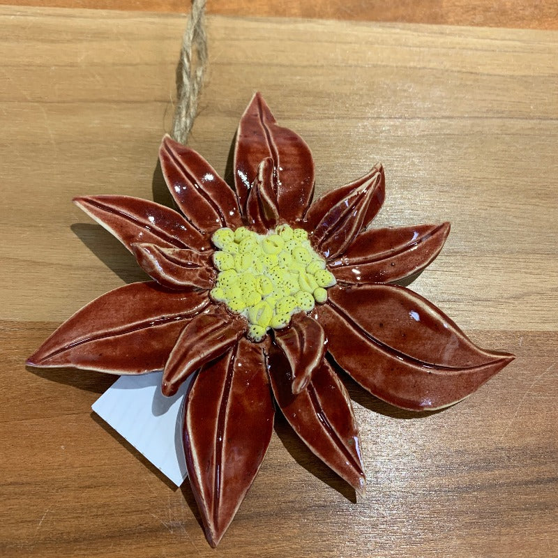 Red pointsettia Christmas ornament with yellow centre