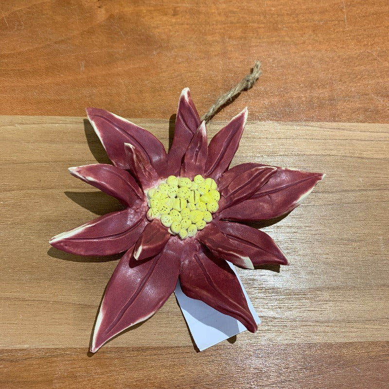Pink pointsettia Christmas ornament with yellow centre