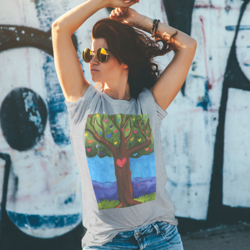 Woman wearing grey tshirt with tree of life decal